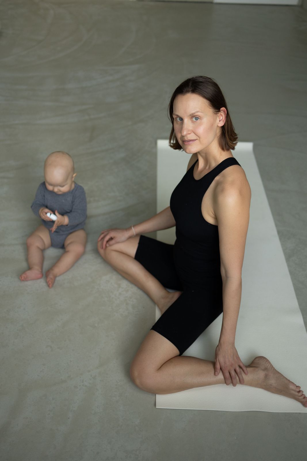 Mom with her baby on a mat at ASA Studio